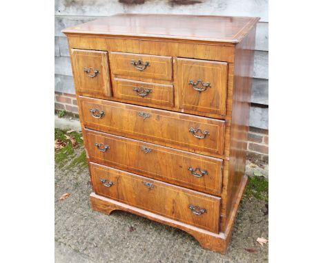 An 18th century walnut and line inlaid chest of four short and three long graduated drawers, on bracket supports, 33" wideCon