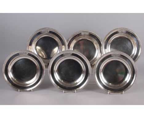 A set of six Georgian silver soup plates with gadrooned borders and engraved armorials, 9 1/2" dia, 111.2oz troy approx Condi