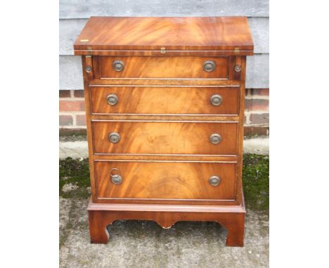 A bachelor's Bevan Funnell figured mahogany fold-over top chest, fitted three drawers, on bracket feet, 23 1/2" wide x 40 1/2