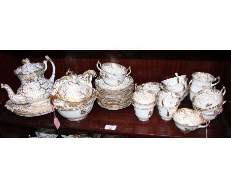 A Rockingham porcelain tea service comprising teapot, slop bowl, lidded sucrier, two cake plates, twelve teacups, seven coffe