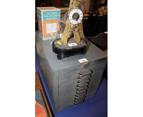 A gilt metal "time recorder", in box, a French skeleton clock movement, miscellaneous clock parts and a grey metal ten drawer