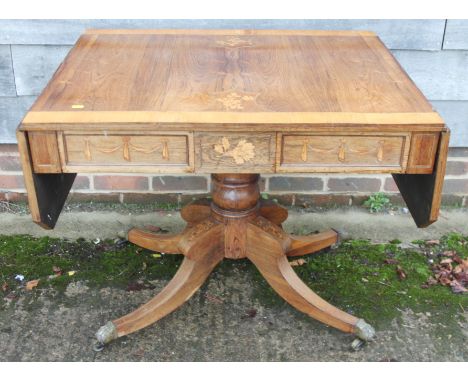 A Regency rosewood box and ebony line inlaid sofa table with floral marquetry panels, fitted two drawers, on faceted centre c