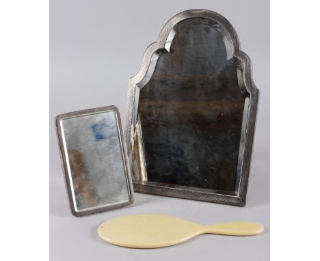 An engine turned silver framed easel mirror with shaped bevelled plate, 12" high and a silver backed travelling easel mirror,