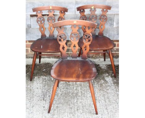 A set of four Ercol single chairs with triple splats pierced Prince of Wales feathers 