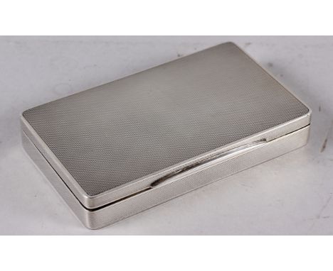 A rectangular solid silver engine turned table cigarette box, 9oz troy approx, Birmingham 1937 