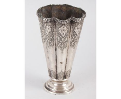 A Middle Eastern white metal fluted vase with engraved decoration, 5 1/4" high 