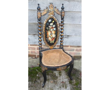 A mid 19th century papier-mache black japanned and mother-of-pearl inlaid splat back low seat nursing chair with cane seat, o