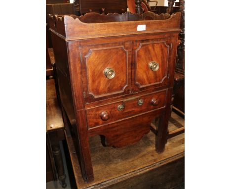 A late Georgian mahogany tray top bedside cupboard/commode, fitted two drawers, central recess and one long drawer, 20" wide 