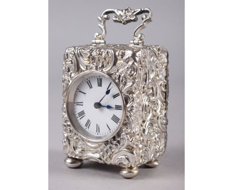 A late Victorian silver cased miniature carriage clock with embossed Rococo decoration, white enamel dial with Roman numerals