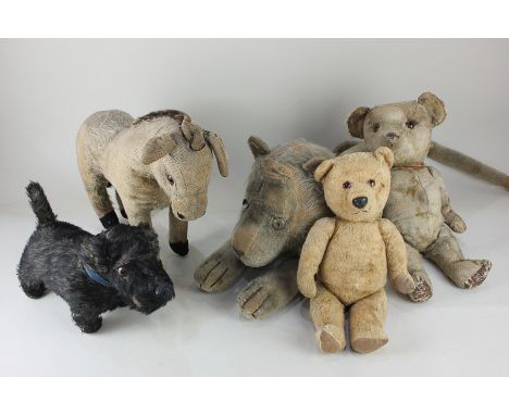 A Chiltern donkey from a pull-along toy, together with two early 20th century teddy bears, a black dog and a lion nightdress 