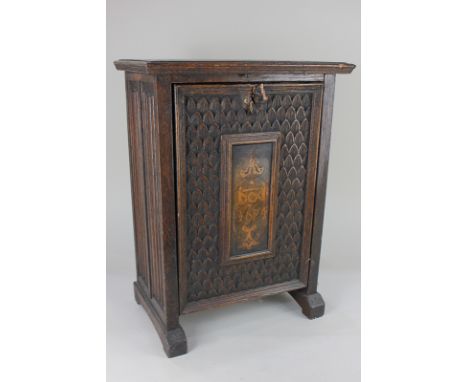A carved oak stationary box, with linen panel sides, and hinged front with plaque bearing date 1624, enclosing fitted interio