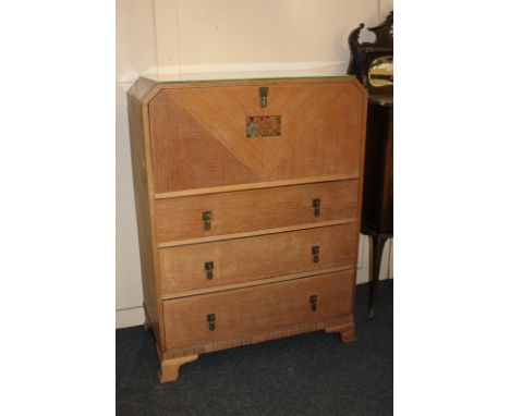 A Warring and Gillows Art Deco limed oak cabinet, fall front with carved floral panel, above three drawers, on bracket feet, 