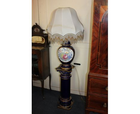 A modern blue glazed pottery table lamp, baluster shape with floral panel, a matching column plinth with gilt highlights, mad