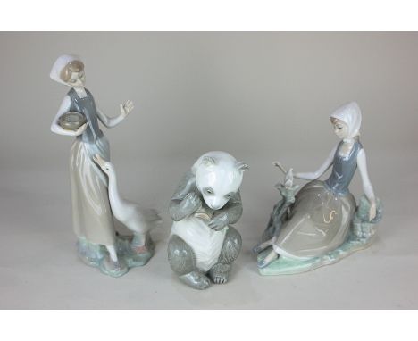 A Lladro porcelain figure of a girl seated beside a dove, 17cm, another feeding a goose, 23cm, together with a Nao model of a