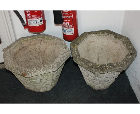 A pair of octagonal composite garden planters, decorated in light relief with stone design, 41.5cm diameter