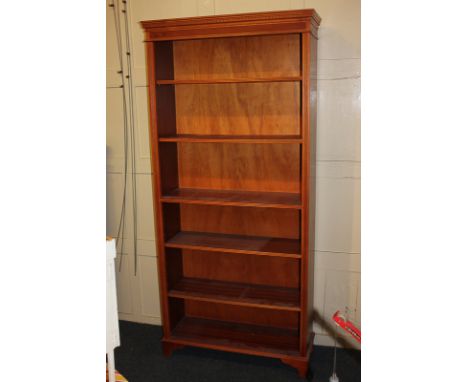 A yew wood reproduction open bookcase, with dentil cornice and five shelves, on bracket base, 88cm 
