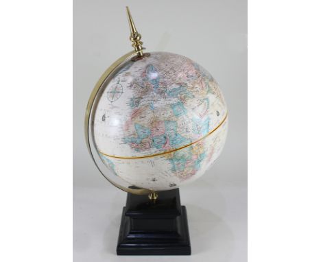 A table top globe, by Replogle, marked '12 inch diameter Globe, World Classic series', with gilt metal mount on black plinth,