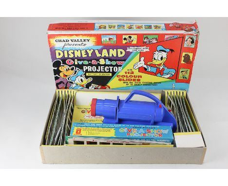 A Chad Valley Disneyland 'Give a Show' projector in box with slides