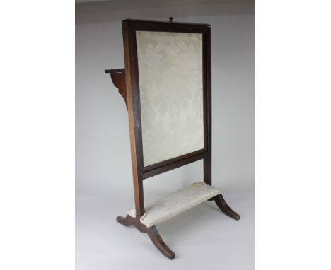 A George III mahogany fire screen with sliding fabric panel, upholstered footstool and folding shelf, 41cm