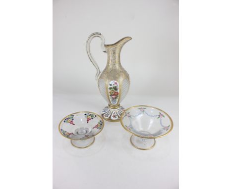 A clear glass and enamel flagon decorated with floral panels and scrolling gilt floral embellishments, 36cm, together with tw