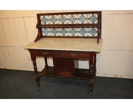 A Victorian mahogany washstand, the tile splash back with single shelf above marble top, with two drawers over single cupboar