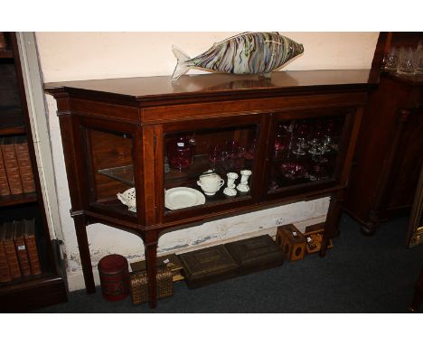 A narrow mahogany break-front display cabinet with two glazed panel doors enclosing a glass shelf, on square tapered legs, 15