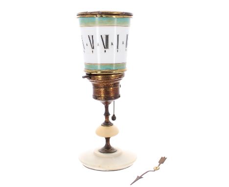 Antique candle clock, the opaque milk glass revolving shade with Roman numerals within gilded green and turquoise borders, su