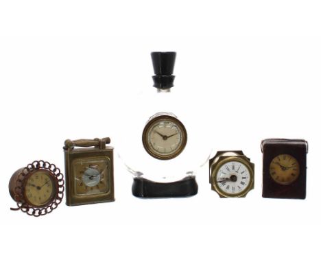 Five small novelty clocks, including a 4" high brass cigarette lighter clock, unusual Maurel Patented brass alarm clock, copp