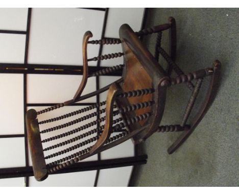 Victorian beech framed rocking chair, bobbin turned back, supports and stretcher, later board seat, patinated Rosewood finish