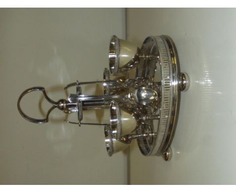 Early 20th century silver plated four egg cup and spoon cruet, reeded egg cups, stand with pieced gallery and carried on bun 