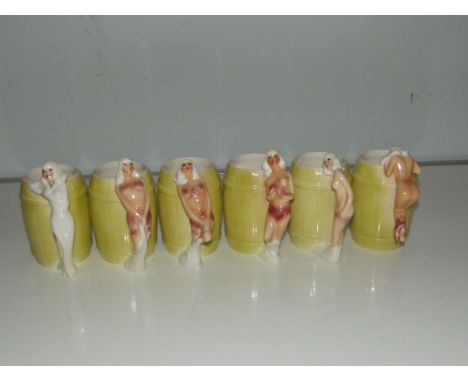 A set of six 1940's cups in the form of barrels with stylised pin up girl handles. Each with a different pose. The lady start