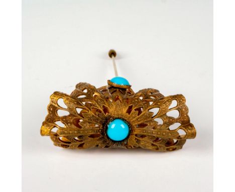 A small brass pin with an ornate decorative head, charming blue enamel details. The shaft includes the end caped. Dimensions: