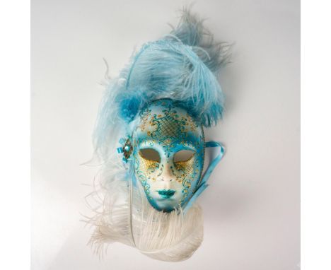 Beautiful mask decorated in a gradient of light blue to cerulean. Plume headpiece on the left side attached to ribbon brooch.