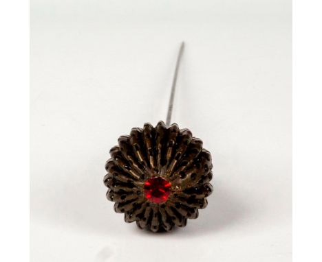 Intricately designed head in the shape of a teardrop, embellished with a ruby red rhinestone and mounted on a metal shank. Di