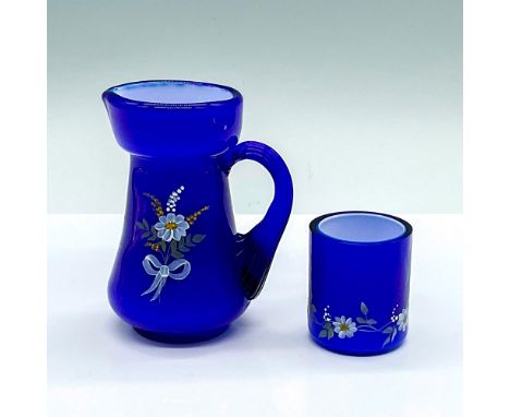 A cobalt blue small jug, and match holder with a milk white interior. Each hand decorated with painted daisies by L. Emerson.