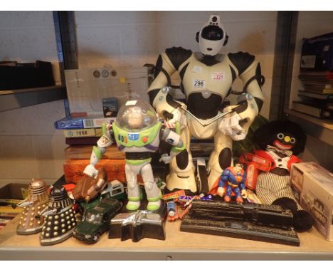 Shelf of toys including Corgi military, Buzz Lightyear, RC Robot games, die-cast, golly etc 