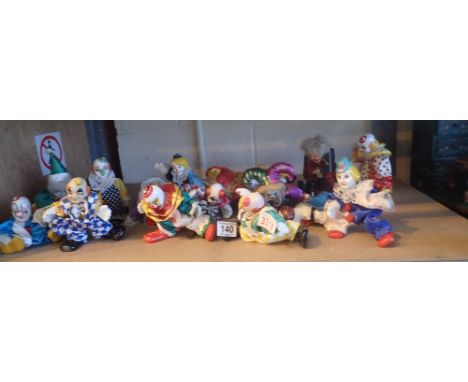 Shelf of soft bodied clowns with ceramic heads and hands