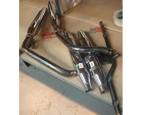 Two pairs of Harley Davidson silencers with mounting bracket 