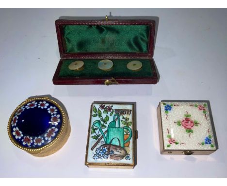 A square enamel pill box, decorated with flowers; others; a set of three mother of pearl collar studs, cased (4) 
