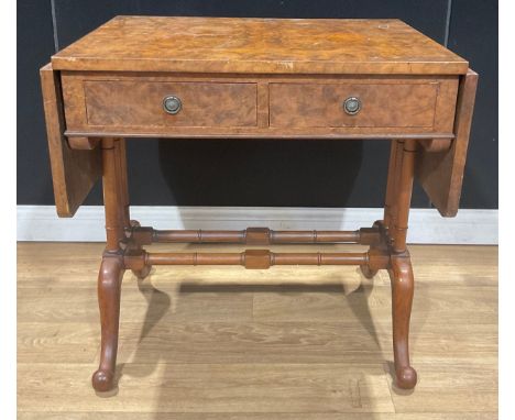 A walnut and mahogany sofa table, rounded rectangular top with fall leaves above a pair of frieze drawers, turned supports an