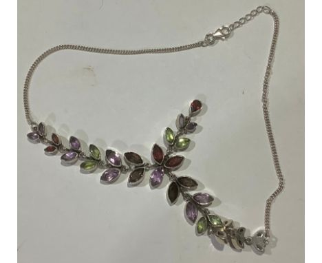 A silver and multi gemstone necklace, set with navette and pear shaped garnets, amethyst, and peridot 