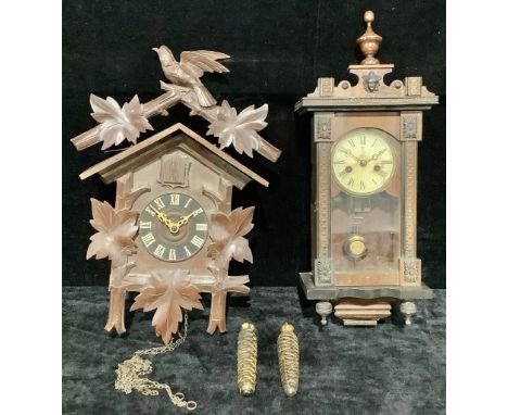 A Vienna style musical wall clock, of small proportions, 52cm high; a Black Forest cuckoo clock (2) 