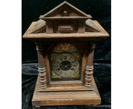 An early 20th century Junghans oak architectural mantle clock, eight-day movement, brass and silvered metal dial, Roman numer