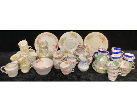 An Edwardian tea service for ten, decorated with yellow flowers, comprising cake plates, side plates, sugar bowl, cream jug, 