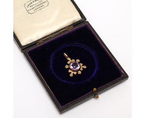 An Edwardian 16ct gold pendant, set with a single faceted amethyst, the border flanked with seed pearls, marked '16C', presen
