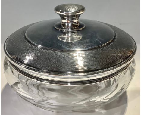 A George V silver and clear glass powder bowl the domed silver cover engine turned, 11cm diameter, Birmingham 1929, the cover