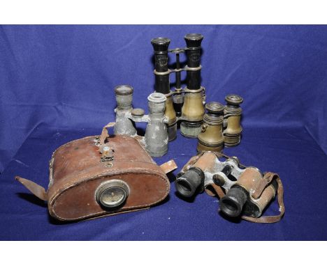 Four individual binoculars, one cased with a compass 