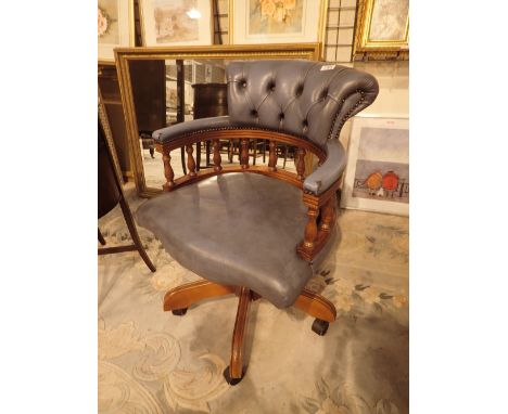 Blue leather swivel armchair on a five star base with button back