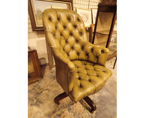 Button back green leather armchair on swivel support