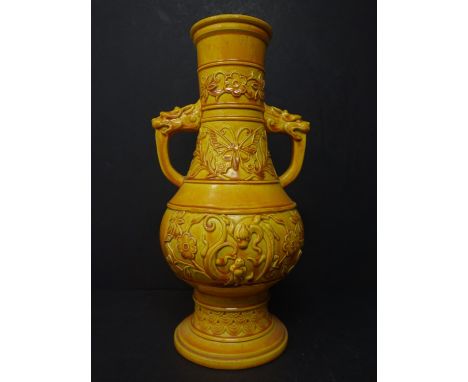 An English yellow glazed ceramic vase of Oriental design, indistinctly marked to base, H.26 W.13cm 